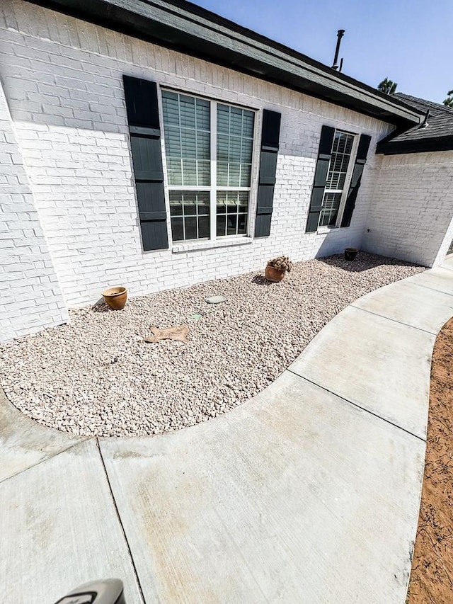 view of exterior entry featuring brick siding