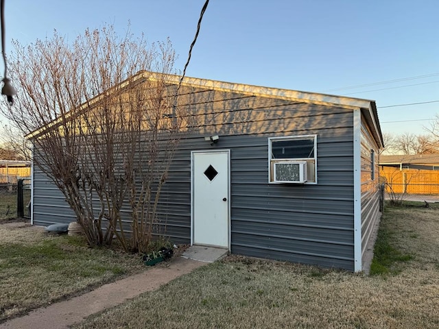 view of outdoor structure featuring cooling unit and a yard