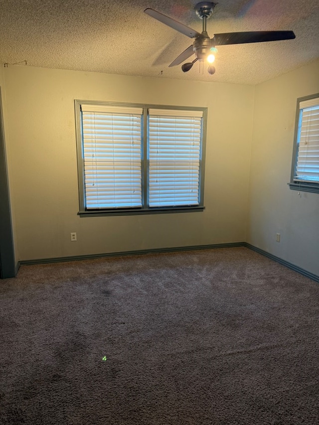 empty room featuring a textured ceiling, ceiling fan, and carpet flooring