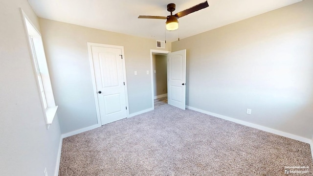 unfurnished bedroom featuring a ceiling fan, baseboards, visible vents, and carpet flooring