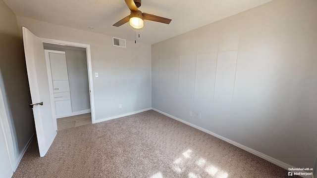 unfurnished room with a ceiling fan, visible vents, and baseboards