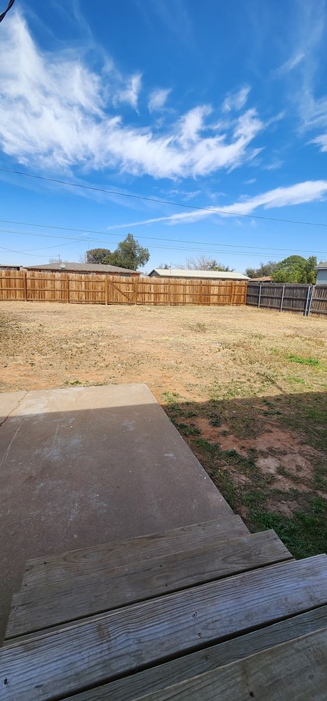 view of yard featuring a patio and a fenced backyard