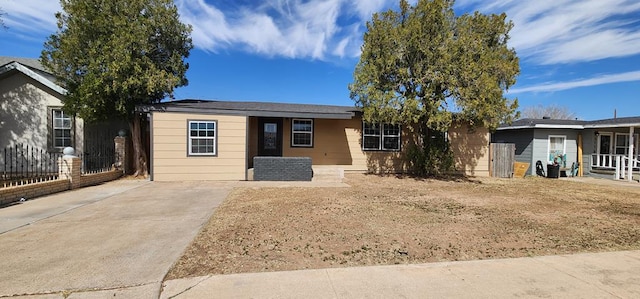 ranch-style house with fence