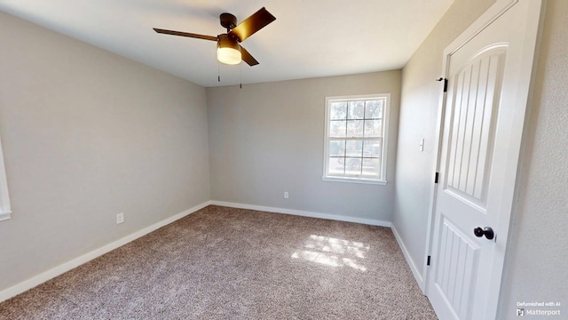 unfurnished bedroom featuring carpet, a ceiling fan, and baseboards