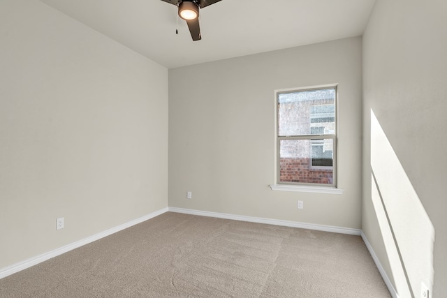 spare room featuring light colored carpet and ceiling fan