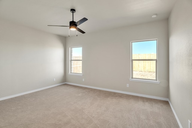 unfurnished room featuring light carpet and ceiling fan