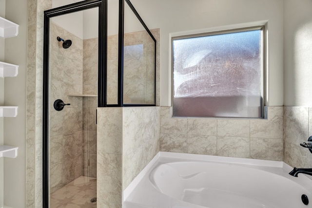 bathroom featuring separate shower and tub