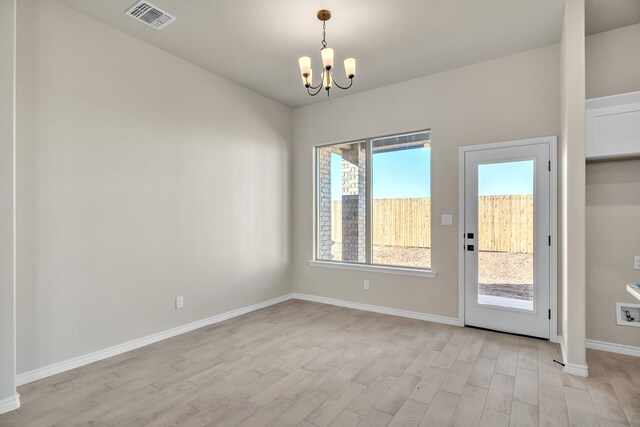 interior space featuring an inviting chandelier and light hardwood / wood-style floors