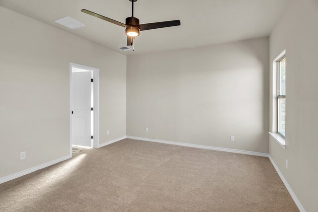 carpeted empty room with ceiling fan and a healthy amount of sunlight