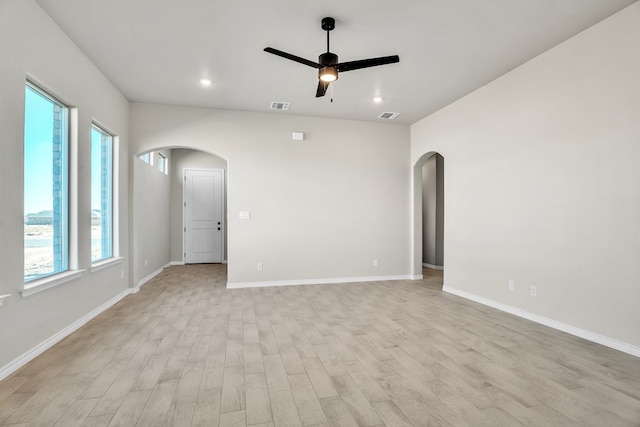 empty room with ceiling fan and light hardwood / wood-style flooring