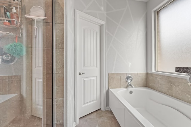 bathroom with a stall shower and a bath