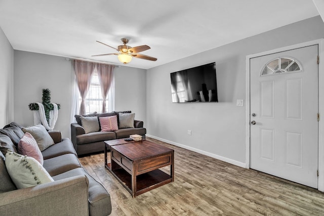 living room with wood-type flooring and ceiling fan