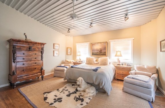 bedroom with multiple windows and hardwood / wood-style floors