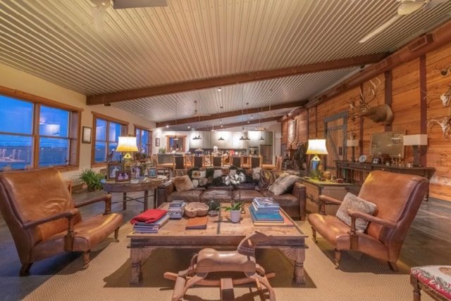 interior space with beam ceiling and wooden walls