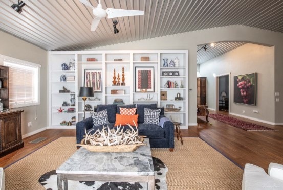 living room featuring ceiling fan, vaulted ceiling, and hardwood / wood-style flooring