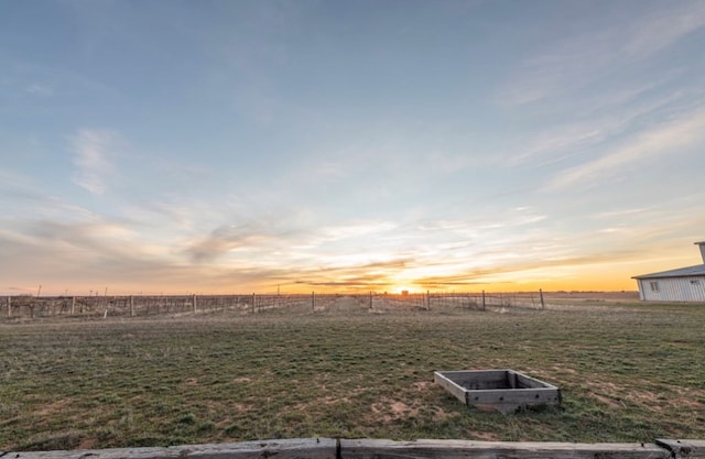 yard at dusk with a rural view