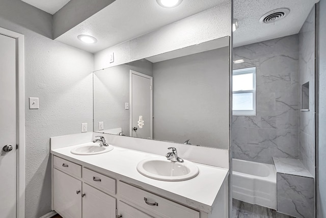 bathroom with a sink, visible vents, wood finished floors, and double vanity