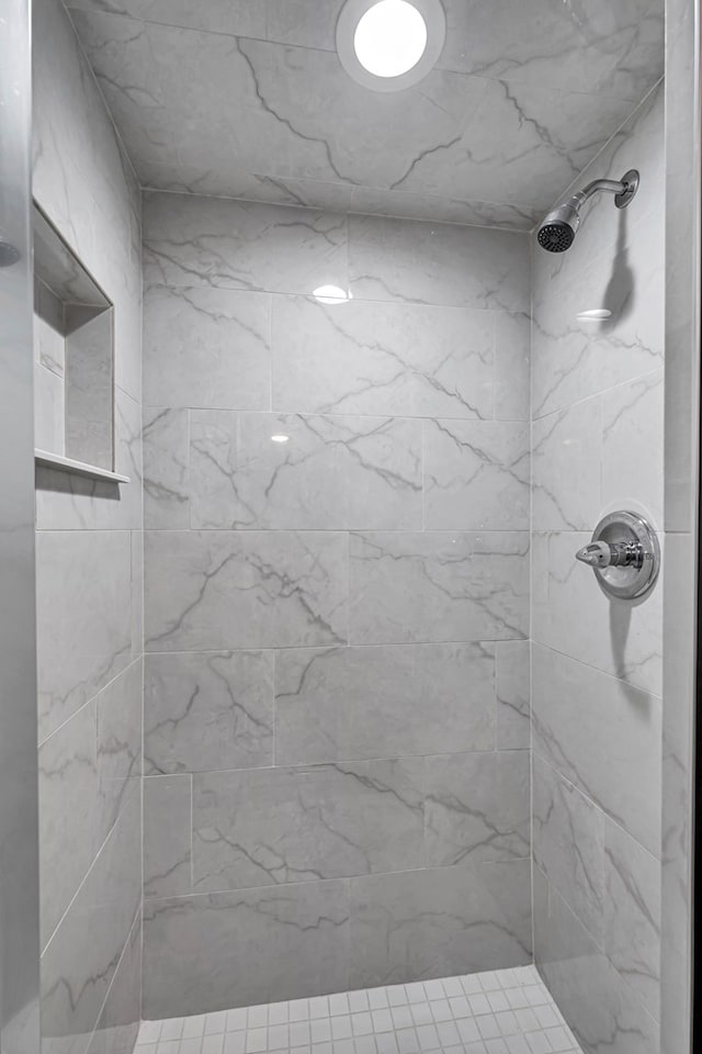 bathroom with tiled shower