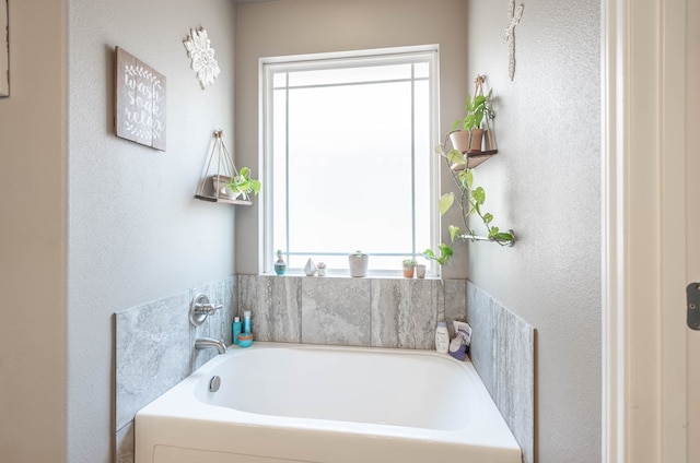 6108 Copper Sky Ct, Midland, TX 79705 - full bath with healthy amount of natural light, a garden tub, and a textured wall