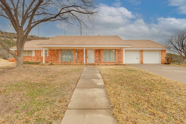 ranch-style house with a garage and a front yard