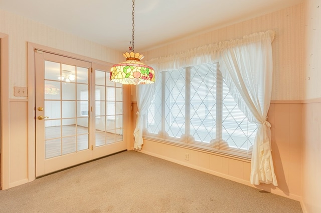 unfurnished dining area featuring carpet flooring