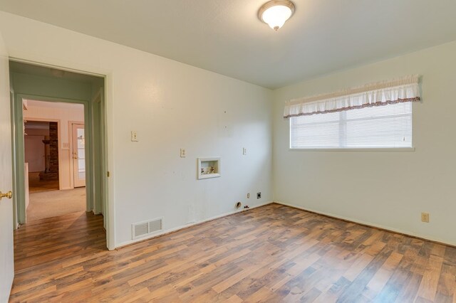 unfurnished room featuring hardwood / wood-style flooring