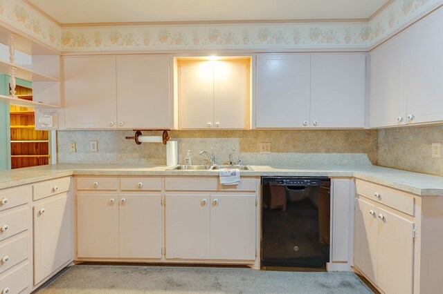 kitchen with white cabinetry, black dishwasher, sink, and backsplash