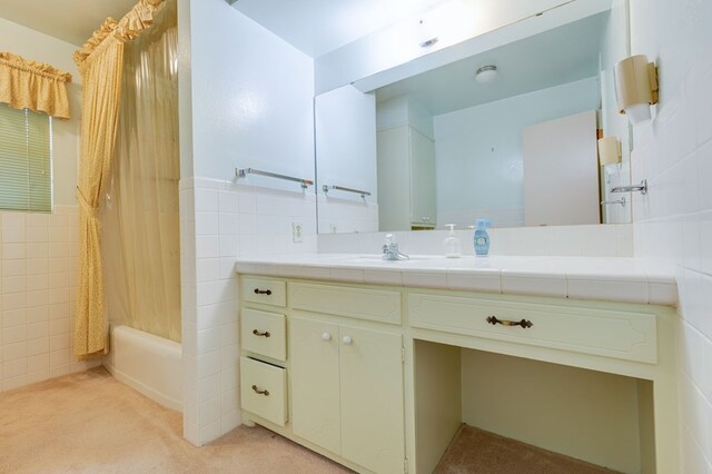 bathroom featuring vanity, tile walls, and shower / bath combination with curtain