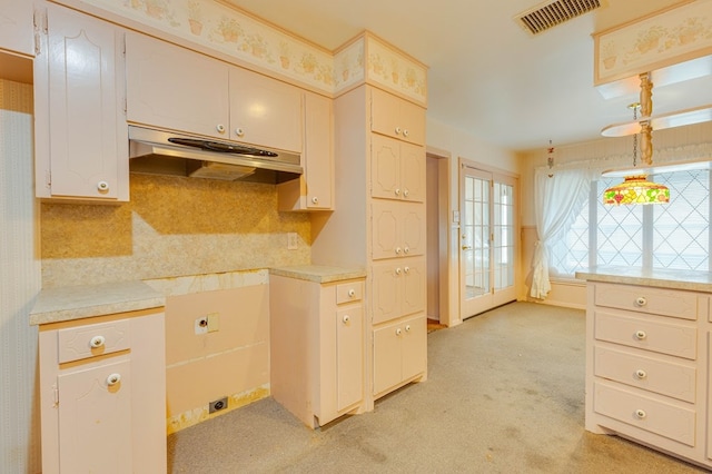 kitchen with tasteful backsplash and light carpet