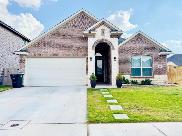 view of front of home with a garage and a front lawn