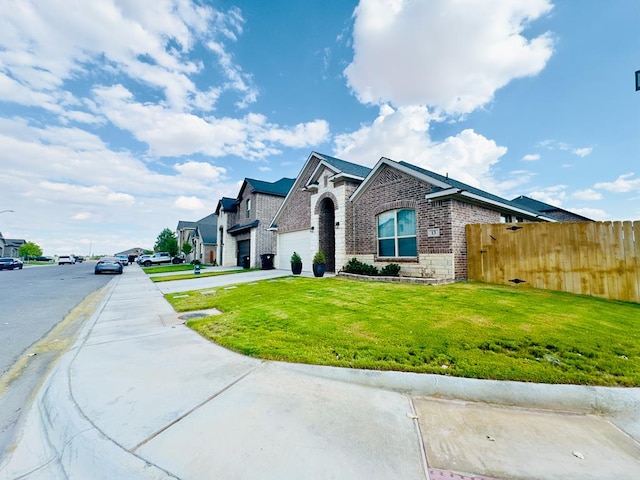 view of front of house featuring a front yard and a garage