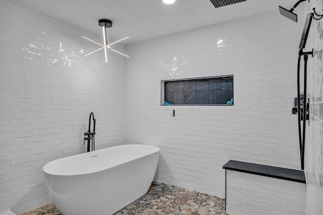 full bath featuring a freestanding tub, tile walls, and a tile shower