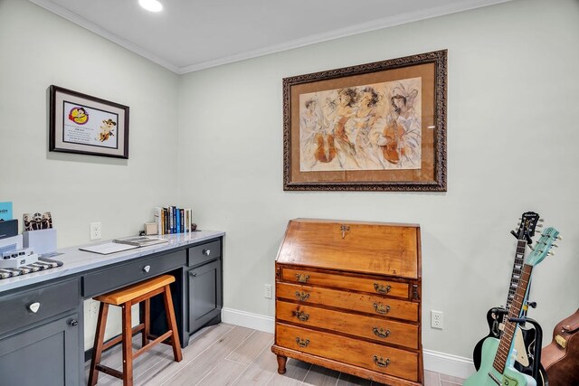 office with light wood-type flooring, crown molding, and baseboards