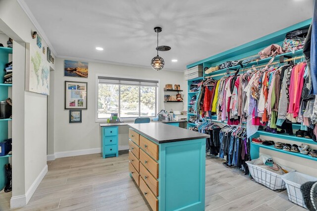 walk in closet with light wood-style flooring