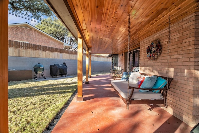 view of patio / terrace featuring a grill and fence