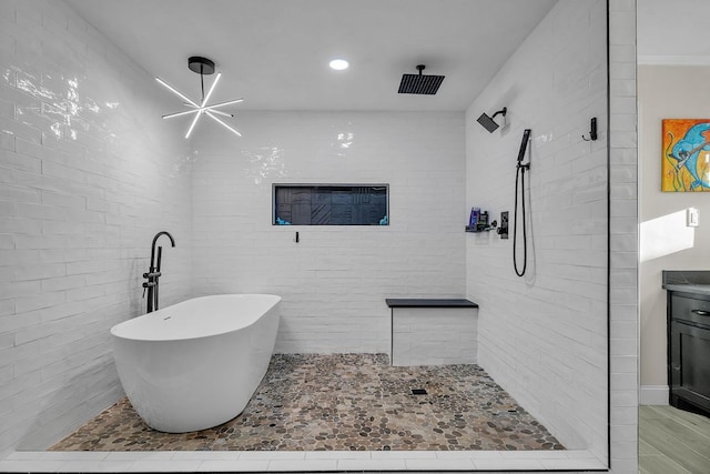 bathroom with tiled shower, recessed lighting, and a freestanding bath