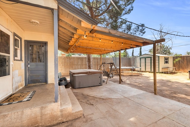 1400 W Tennessee Ave, Midland, TX 79701 - fenced backyard with a patio area, a trampoline, and a hot tub