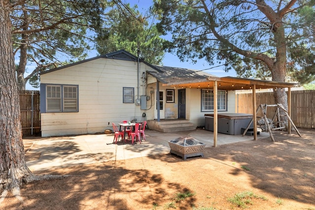 1400 W Tennessee Ave, Midland, TX 79701 - back of property with a hot tub, a patio area, and a fire pit