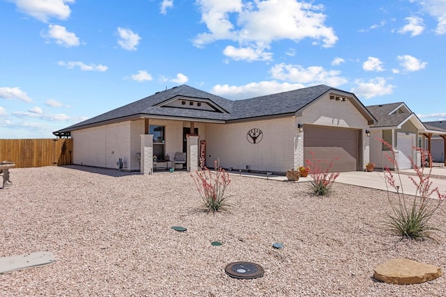 1201 Bajada St, Midland, TX 79705 - ranch-style home with brick siding, an attached garage, concrete driveway, and a shingled roof