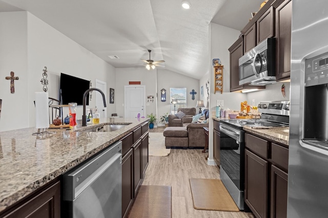 1201 Bajada St, Midland, TX 79705 - kitchen featuring appliances with stainless steel finishes, a sink, light wood finished floors, lofted ceiling, and a ceiling fan