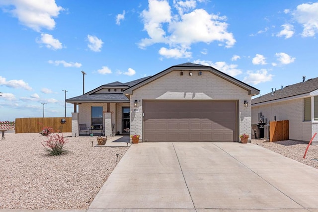 1201 Bajada St, Midland, TX 79705 - ranch-style house featuring brick siding, concrete driveway, and an attached garage