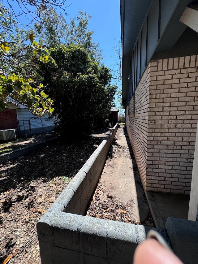 view of side of home with central AC unit