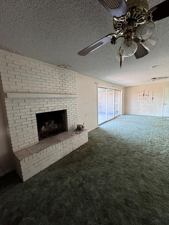 unfurnished living room featuring ceiling fan, carpet, a textured ceiling, and a brick fireplace