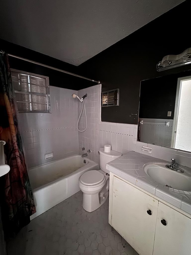 full bathroom featuring vanity, tile patterned floors, toilet, tile walls, and shower / tub combo with curtain