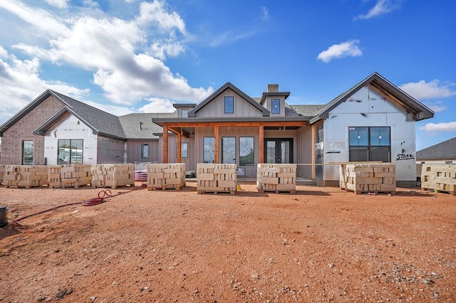 5708 E County Rd 93, Midland, TX 79706 - rear view of property with french doors, an outdoor living space, a chimney, and board and batten siding