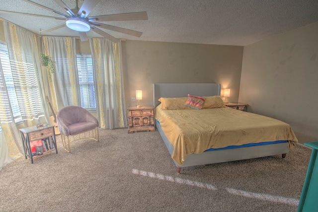 carpeted bedroom with a textured ceiling and ceiling fan