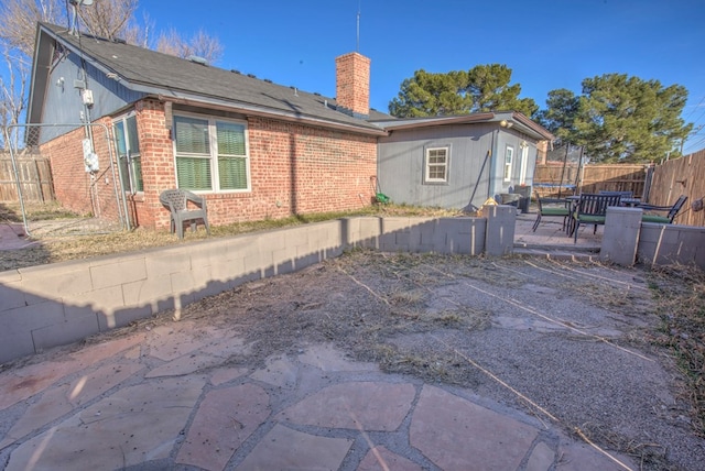 back of property with a patio