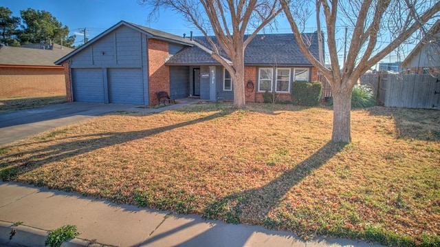 view of front of property featuring a garage and a front yard