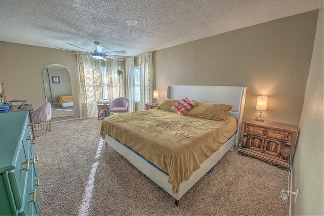 bedroom with ceiling fan and a textured ceiling