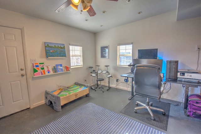 home office with concrete flooring and ceiling fan